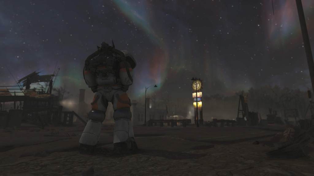 An in-game screenshot from Fallout 76 of me in a my power armor looking at a gas station in the newest update with what looks like the aurora borealis in the sky.